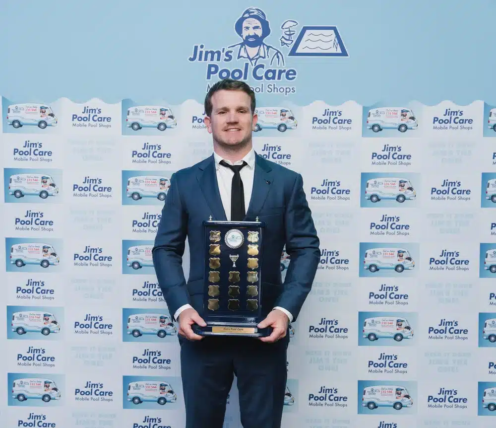 James Steltenpool of Jim's Pool Care Toronto holding the Franchisee of the Year 2026 perpetual trophy