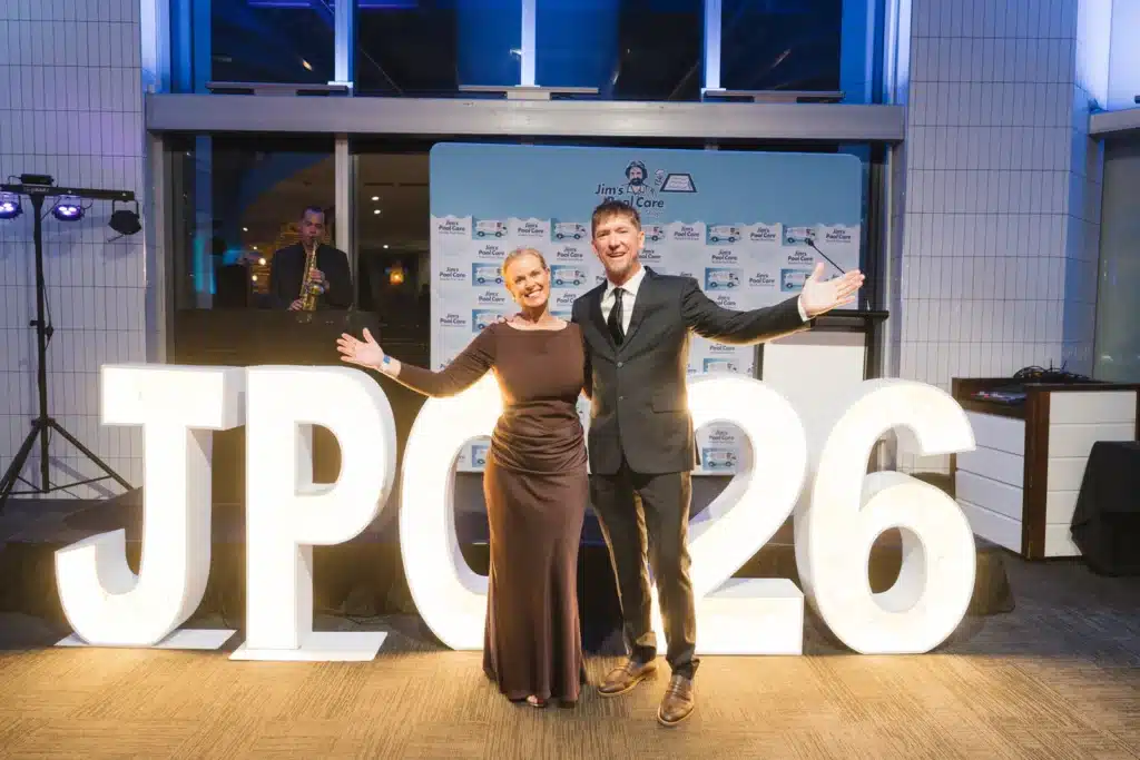 Jim's Pool Care franchisors on stage with illuminated JPC 26 letters at the 2026 National Awards night