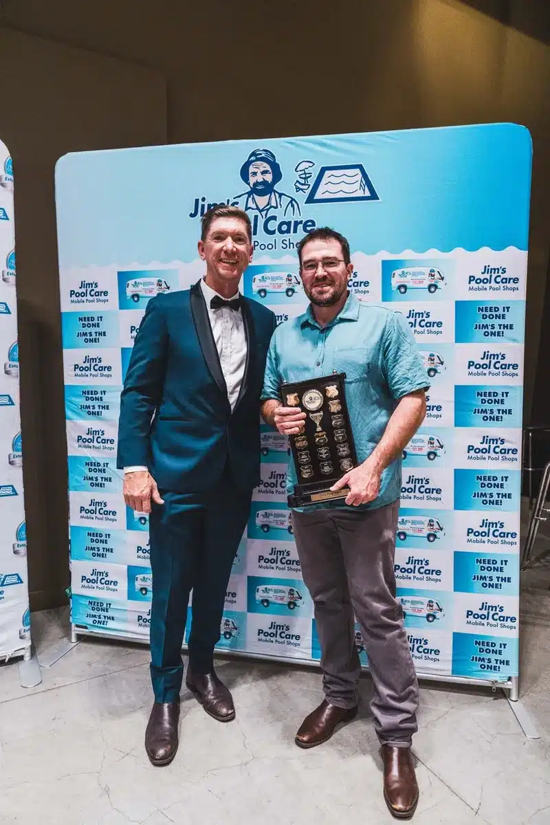 Jim's Pool Care Franchisee of the Year 2025 award winner holding the national perpetual trophy