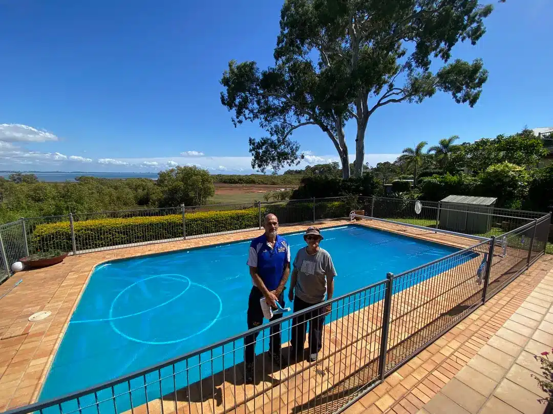 Jim's Pool Care technician with a Wellington Point pool owner beside a covered swimming pool