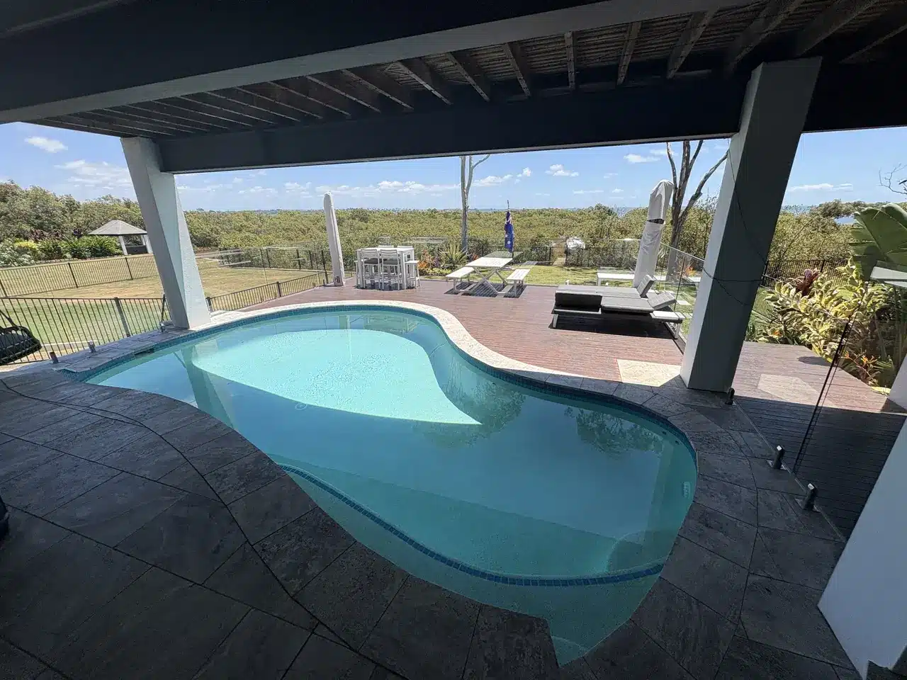 Clean backyard swimming pool under a pergola at a Wellington Point home