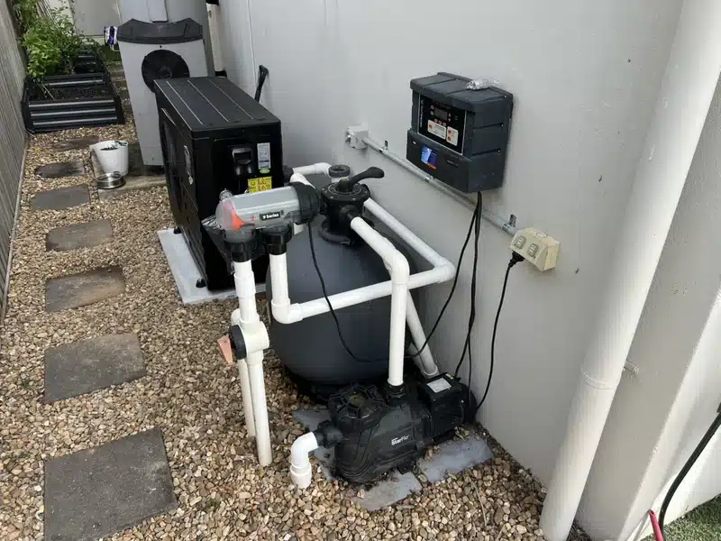 Townsville pool equipment setup showing a pool heat pump, sand filter, StarFlo pool pump and salt chlorinator control unit